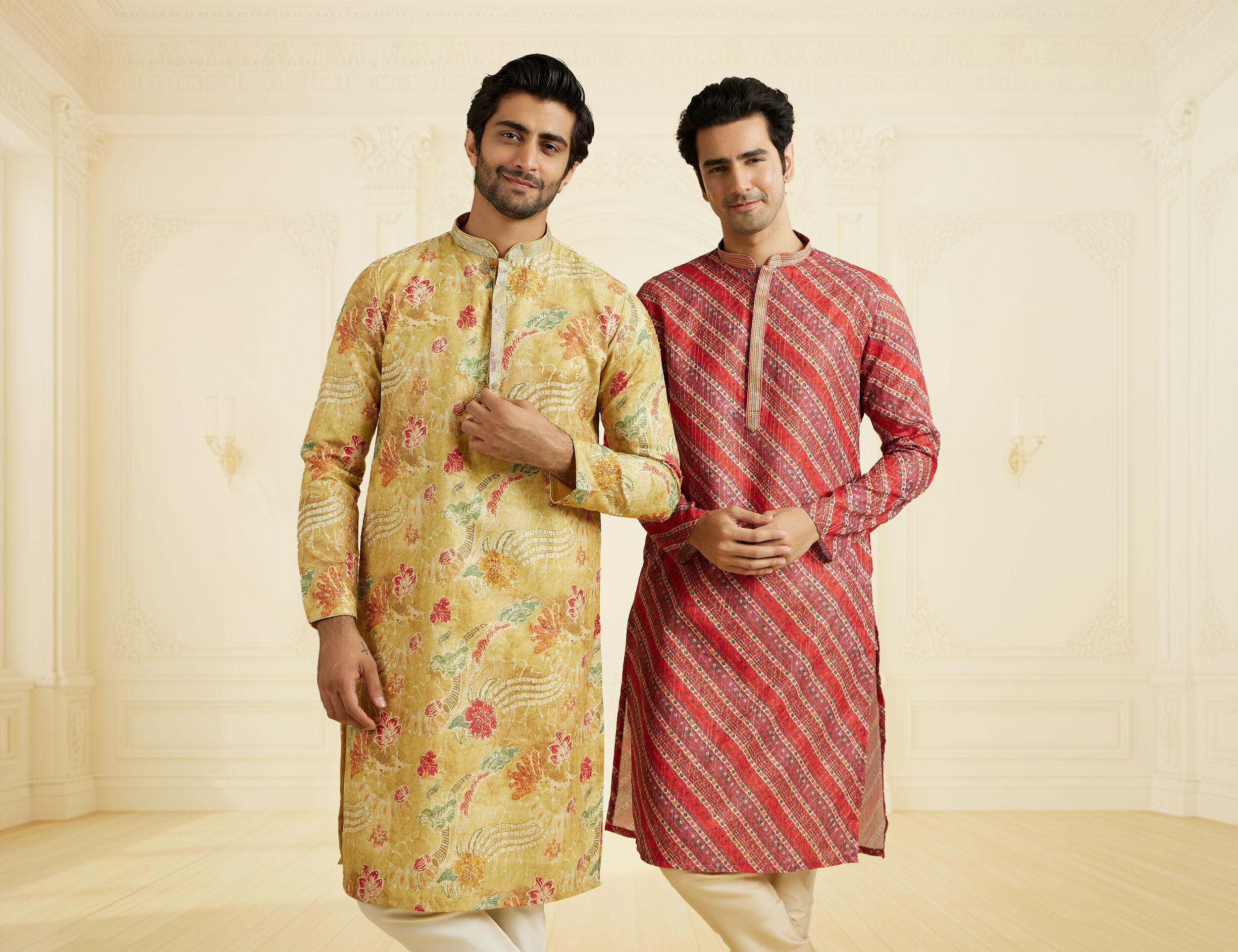 Men dressed in mustard yellow and red silk printed kurtas, exuding traditional elegance.